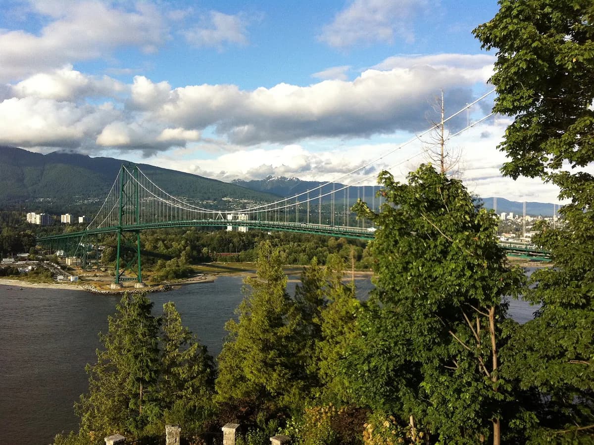 The Lions Gate Bridge seen from above through the trees at Prospect Point