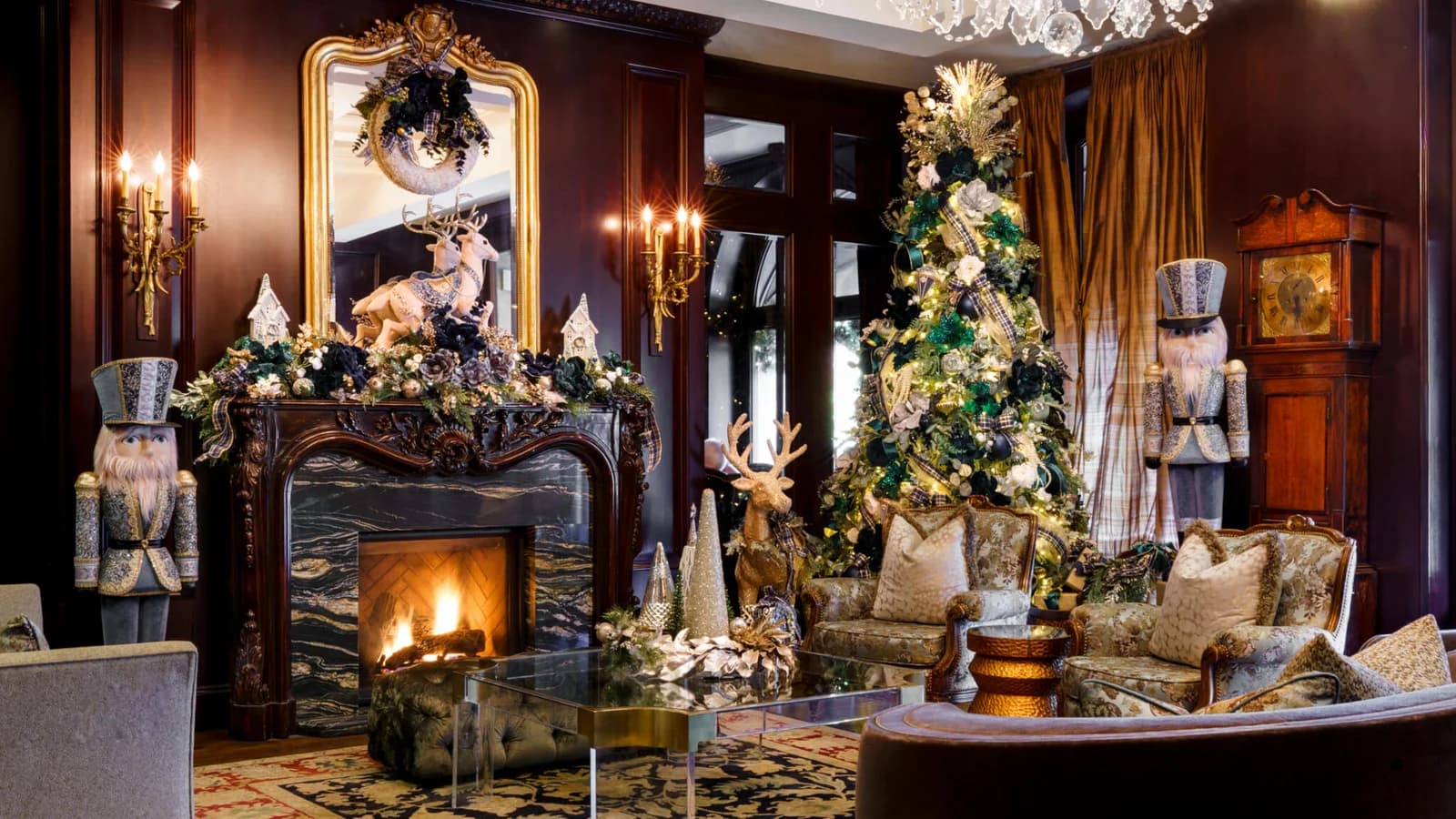 A Wedgewood Hotel lounge dressed for a previous holiday season, with nutcracker figures, a lit fireplace and a decorated tree, from the hotel's own photos