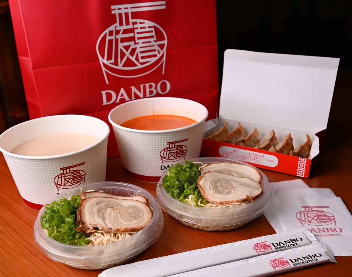 Bowls of ramen, gyoza in a box, DANBO bags and chopstick sleeves from Danbo Express