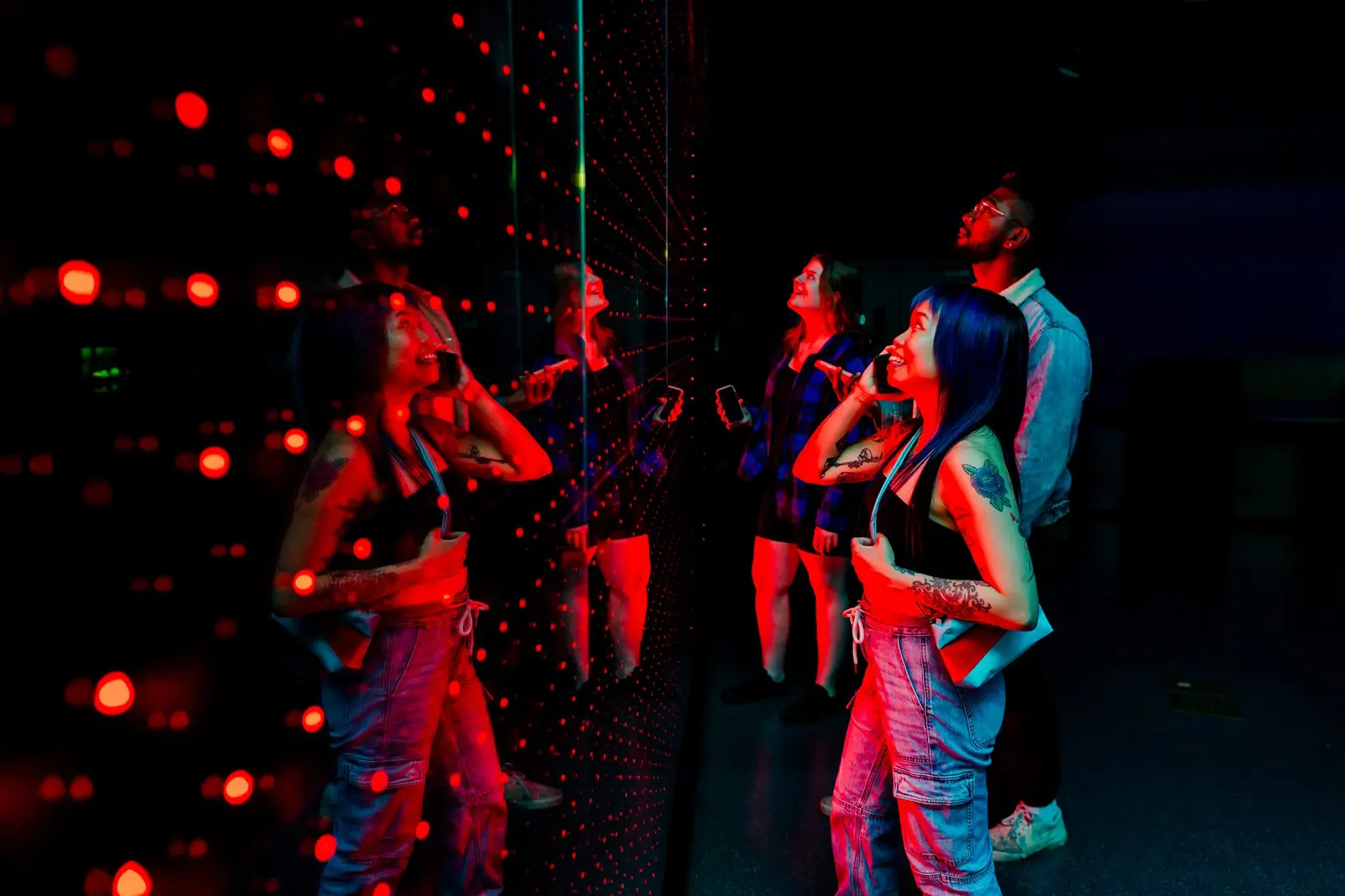 People stand and interact with a light installation during a past Science World After Dark event.