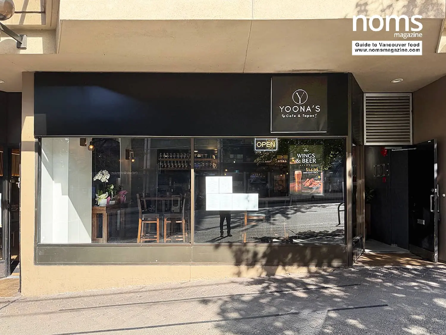 Storefront of Yoona's Café & Tapas on Robson Street with large windows and an illuminated sign